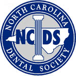 The image is a logo for the North Carolina Dental Society, which includes text and an emblem representing dental services.